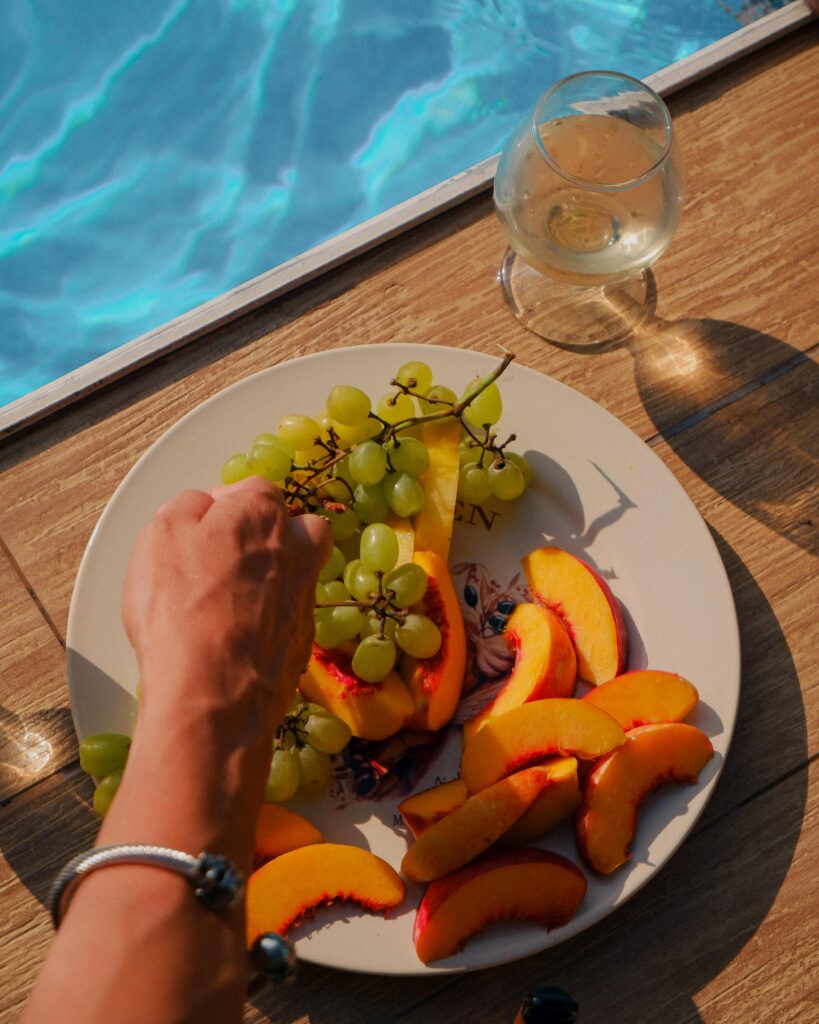 Enjoy a relaxing summer day with fresh fruits and a poolside view in Ukraine.