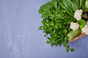 variety of vegetables on a wooden board on blue background